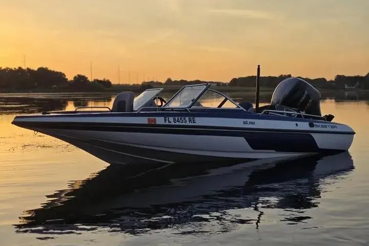 Slide: The Image of 2017 Skeeter SL 190 boat on calm water at sunset. - 24