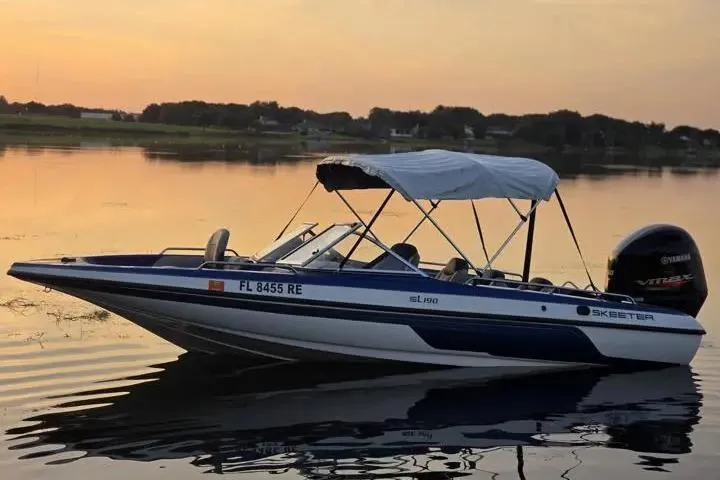 Slide: The Image of 2017 Skeeter SL 190 boat on calm lake at sunset with canopy. - 25