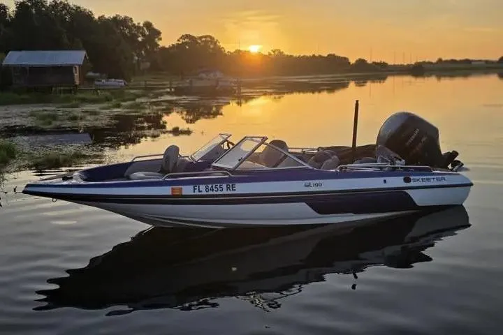 Slide: The Image of 2017 Skeeter SL 190 boat on serene lake at sunset. - 28