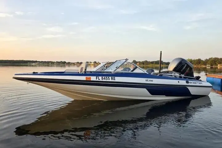Slide: The Image of 2017 Skeeter SL 190 boat on calm lake at sunset. - 30