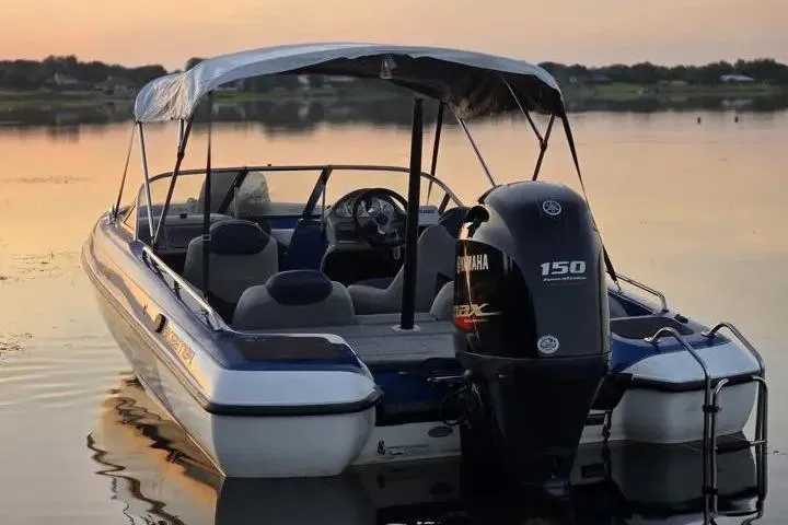 Slide: The Image of 2017 Skeeter SL 190 boat with Yamaha 150 engine on calm water at sunset. - 34