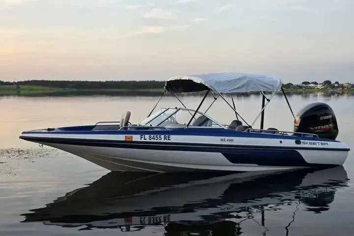 Slide: The Image of 2017 Skeeter SL 190 boat on calm lake at sunset with Yamaha engine. - 4
