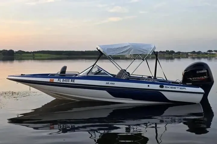 Slide: The Image of 2017 Skeeter SL 190 boat with Yamaha engine on calm lake at sunset. - 6