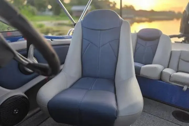 Slide: The Image of 2017 Skeeter SL 190 boat interior with blue and gray seating at sunset. - 8