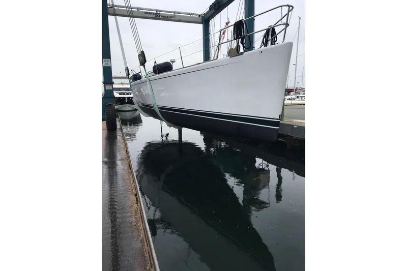 Slide: The Image of Sailboat by Reichel/Pugh, 2007 model, suspended over water at a marina. - 27