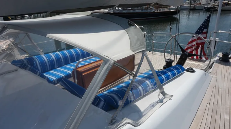 Slide: The Image of Reichel/Pugh 2007 yacht with striped cushions and US flag in harbor. - 7