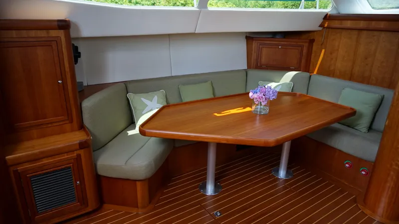 Slide: The Image of Elegant interior of a 2007 Reichel/Pugh yacht with wooden table and seating area. - 9