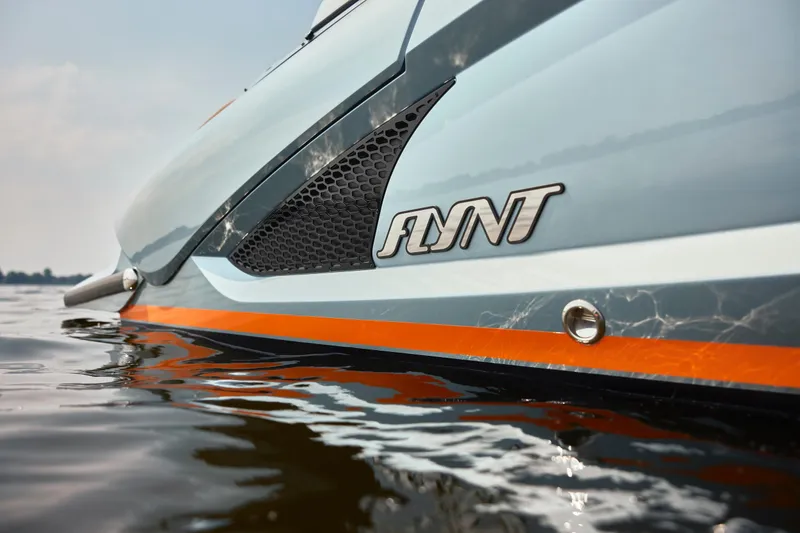 Slide: The Image of 2026 Flynt Yachts Speedera 26 OB on water, showcasing sleek design and branding. - 14