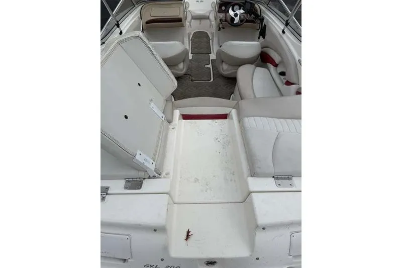Slide: The Image of 2007 Glastron GXL 205 boat interior with white seating and steering wheel. - 10