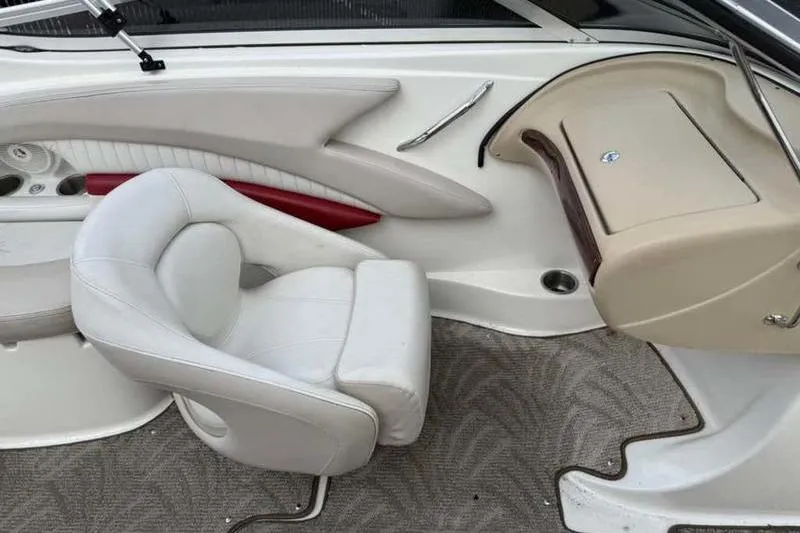 Slide: The Image of Interior of a 2007 Glastron GXL 205 boat with white seating and dashboard. - 12