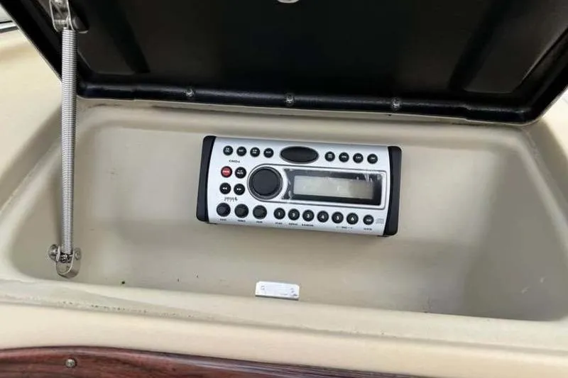 Slide: The Image of 2007 Glastron GXL 205 boat stereo system in dashboard compartment. - 13