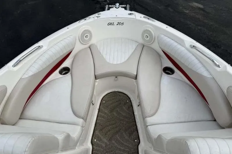 Slide: The Image of 2007 Glastron GXL 205 boat interior with white seating and cup holders. - 16
