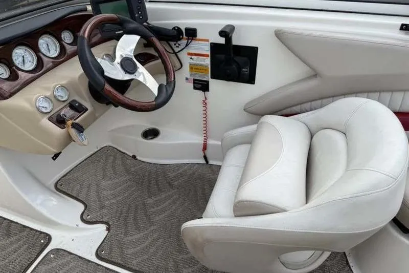 Slide: The Image of 2007 Glastron GXL 205 boat interior with steering wheel and captain's chair. - 17