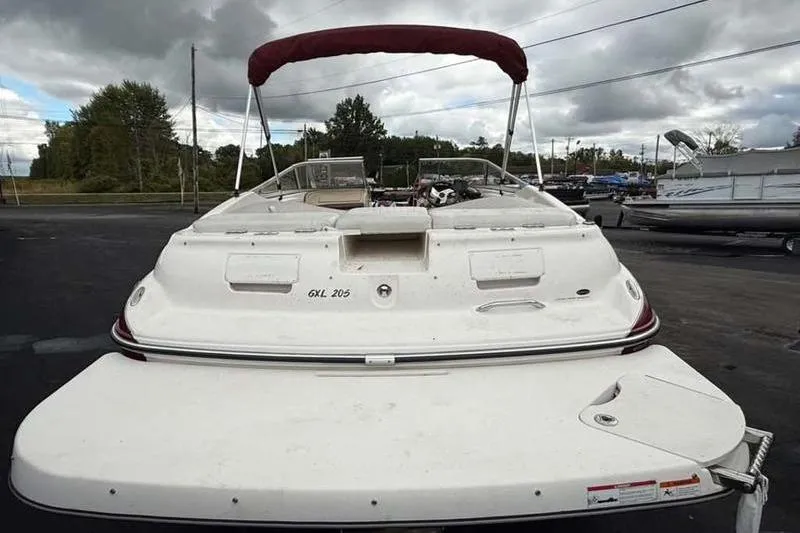 Slide: The Image of 2007 Glastron GXL 205 boat with maroon canopy, parked outdoors. - 3