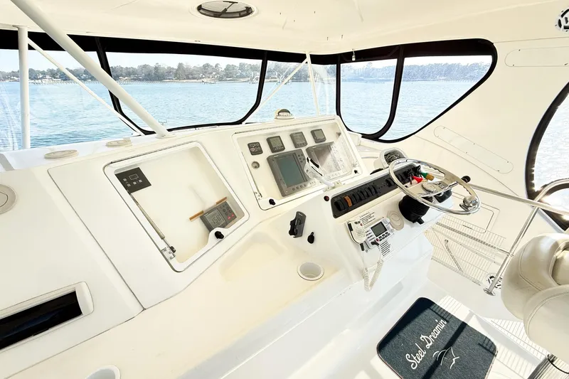 Slide: The Image of 2004 Silverton 48 Convertible yacht helm with navigation instruments and ocean view. - 11