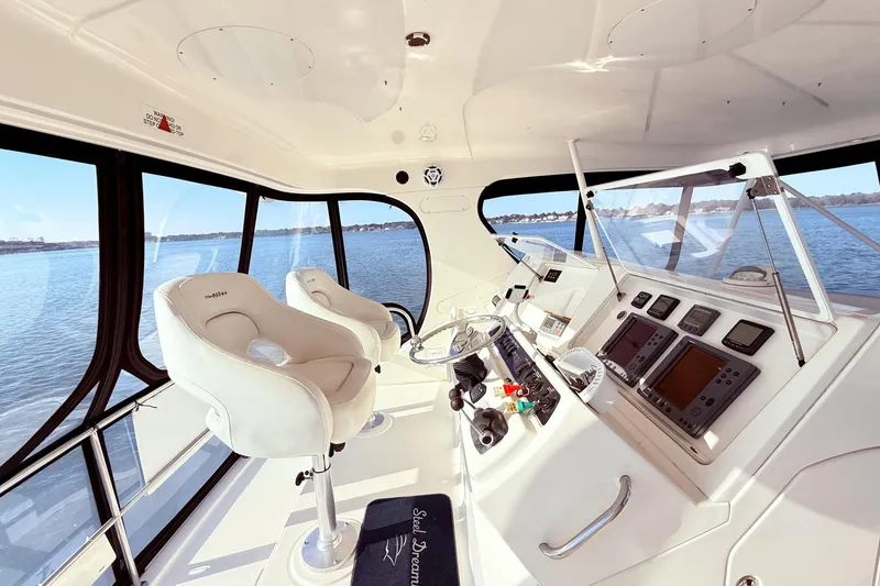 Slide: The Image of Interior of 2004 Silverton 48 Convertible yacht with helm and navigation equipment. - 12