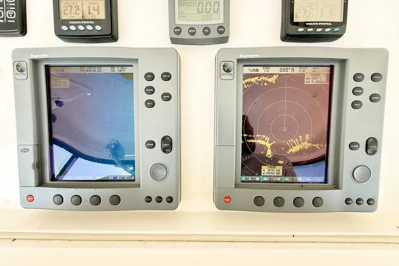 Slide: The Image of Navigation equipment on a 2004 Silverton 48 Convertible yacht dashboard. - 14