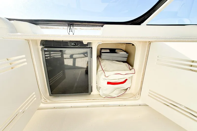 Slide: The Image of 2004 Silverton 48 Convertible yacht interior storage with mini fridge and compartment. - 19