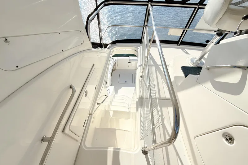 Slide: The Image of 2004 Silverton 48 Convertible yacht interior with stairs and railing, overlooking water. - 20