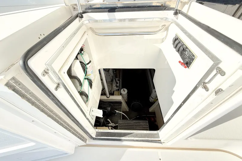 Slide: The Image of Engine room access on 2004 Silverton 48 Convertible yacht, showing equipment and controls. - 29
