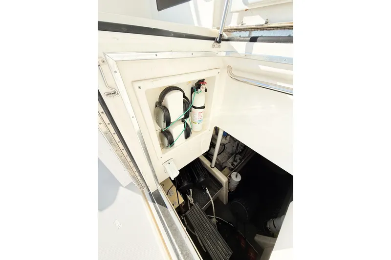 Slide: The Image of Engine compartment of 2004 Silverton 48 Convertible yacht with fire extinguisher and equipment. - 30