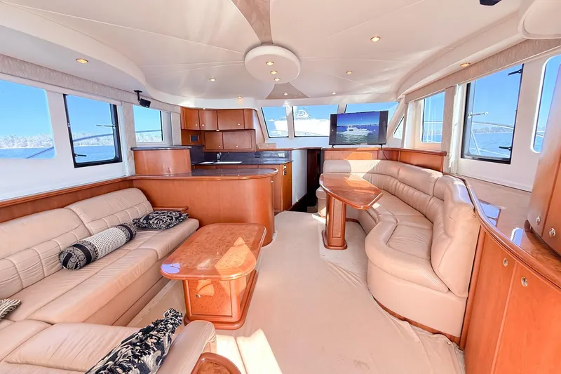 Slide: The Image of Luxurious interior of a 2004 Silverton 48 Convertible yacht with elegant seating and wood finishes. - 31