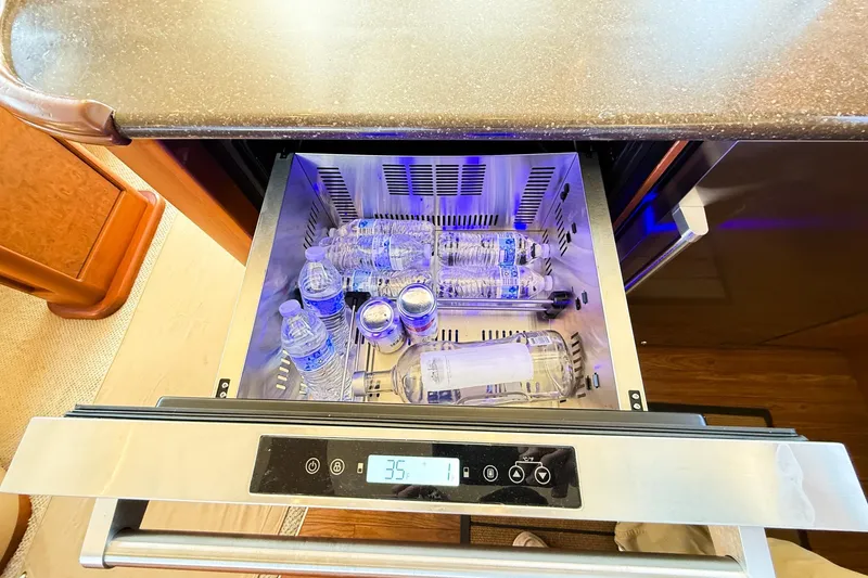 Slide: The Image of Refrigerator drawer with water bottles and cans on a 2004 Silverton 48 Convertible yacht. - 47
