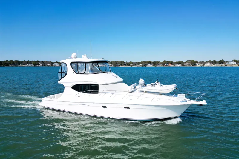 Slide: The Image of 2004 Silverton 48 Convertible yacht cruising on a sunny day. - 5