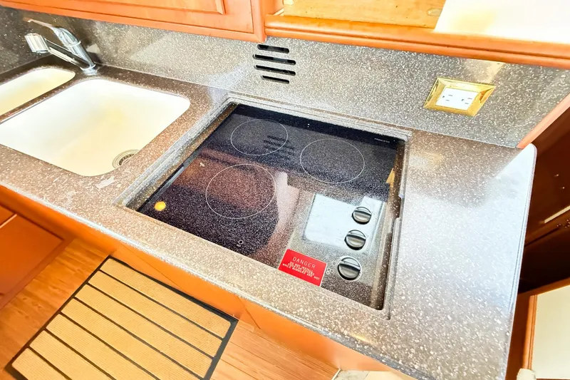 Slide: The Image of 2004 Silverton 48 Convertible kitchen with electric stove and sink. - 50