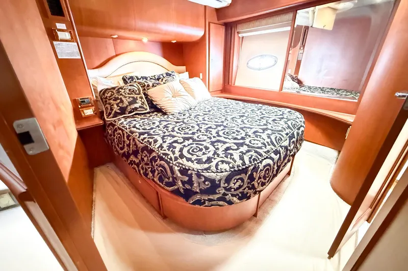 Slide: The Image of Luxurious bedroom interior of 2004 Silverton 48 Convertible yacht with elegant bedding. - 55