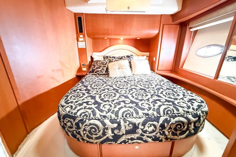 Slide: The Image of Luxurious bedroom interior of 2004 Silverton 48 Convertible yacht with elegant bedding. - 56