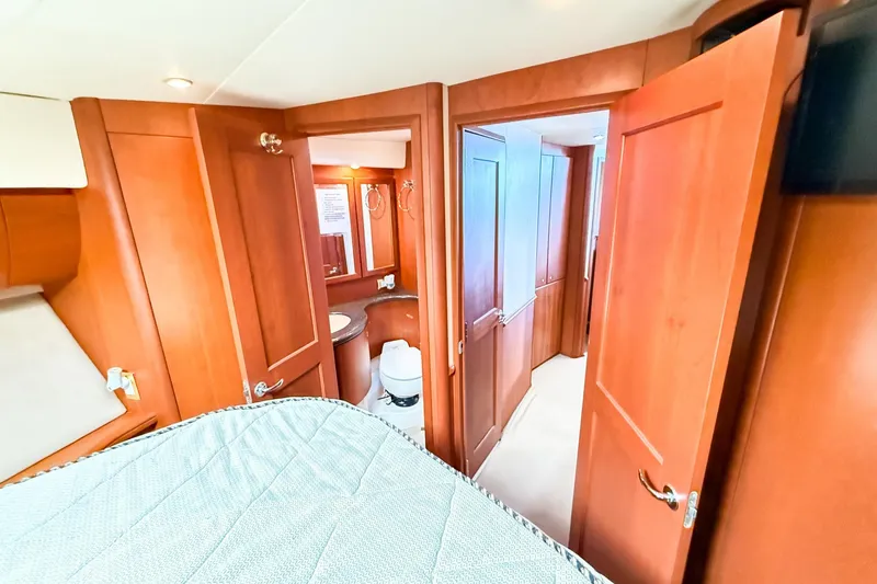 Slide: The Image of Interior of 2004 Silverton 48 Convertible yacht with wooden doors and cozy cabin. - 62