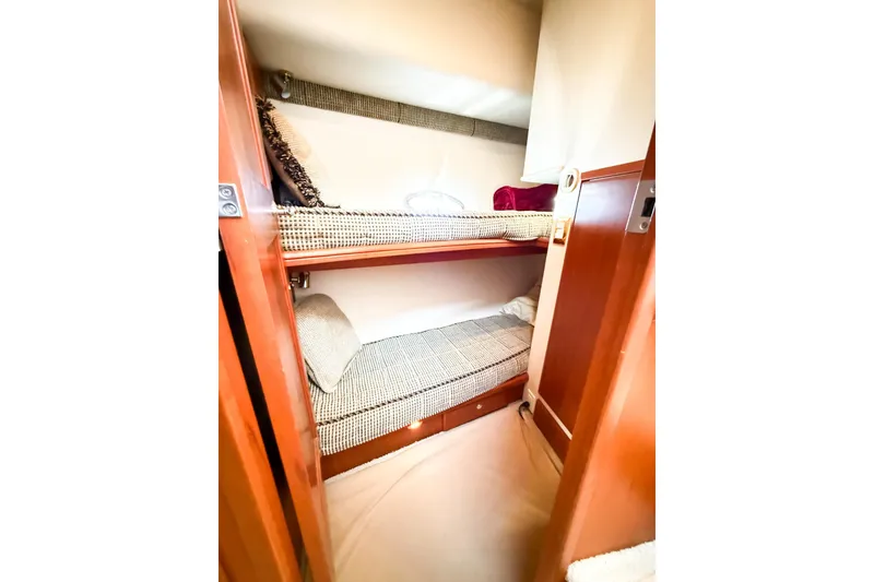 Slide: The Image of 2004 Silverton 48 Convertible yacht interior with cozy bunk beds and wooden finish. - 64