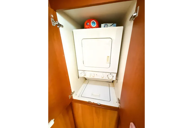 Slide: The Image of Stacked washer and dryer in 2004 Silverton 48 Convertible yacht cabinet. - 65