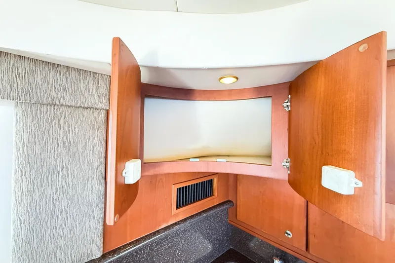 Slide: The Image of Open wooden cabinet in 2004 Silverton 48 Convertible yacht interior. - 70