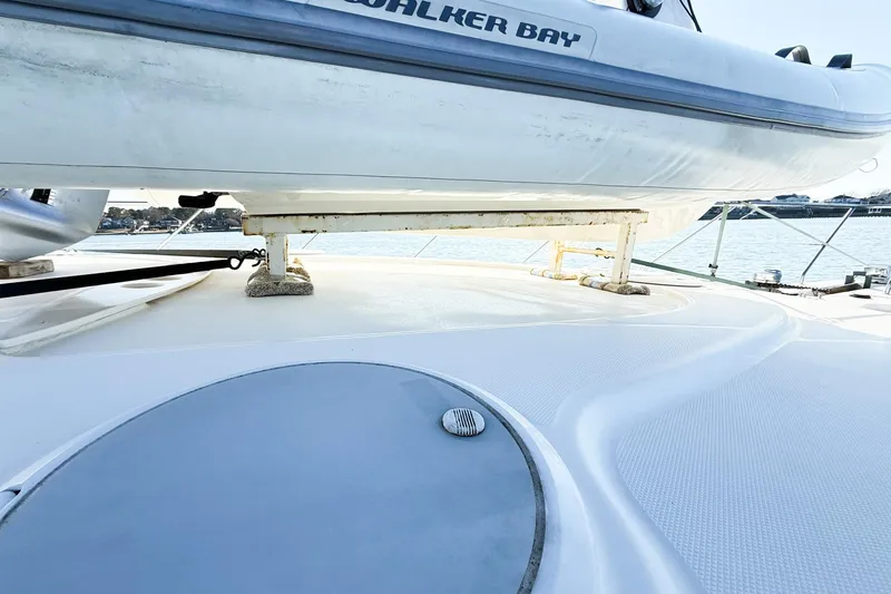 Slide: The Image of 2004 Silverton 48 Convertible yacht deck with Walker Bay boat, docked by the water. - 74