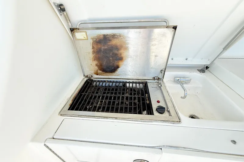 Slide: The Image of Outdoor grill and sink on 2004 Silverton 48 Convertible yacht. - 76
