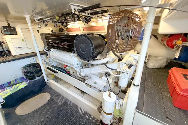 Slide: The Image of Engine room of a 2004 Silverton 48 Convertible yacht, featuring a diesel engine and equipment. - 79