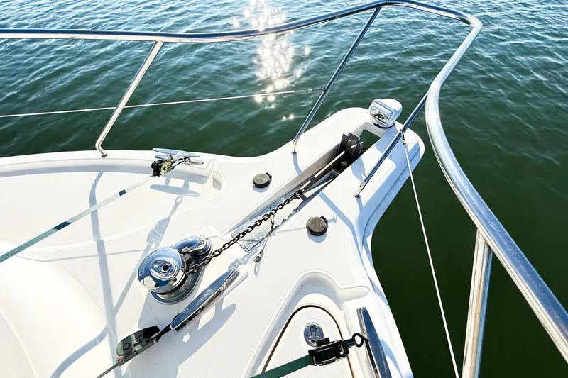 Slide: The Image of Bow of 2004 Silverton 48 Convertible yacht with anchor and railing over water. - 8