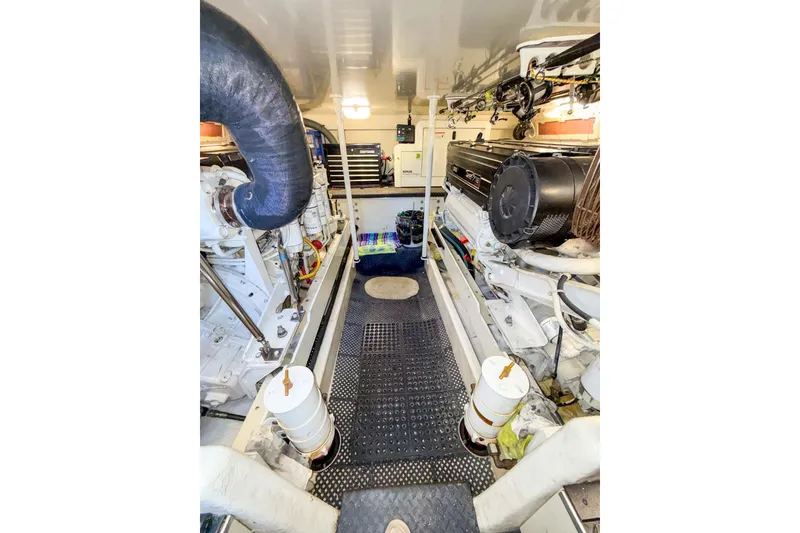 Slide: The Image of Engine room of a 2004 Silverton 48 Convertible yacht, showcasing machinery and equipment. - 80