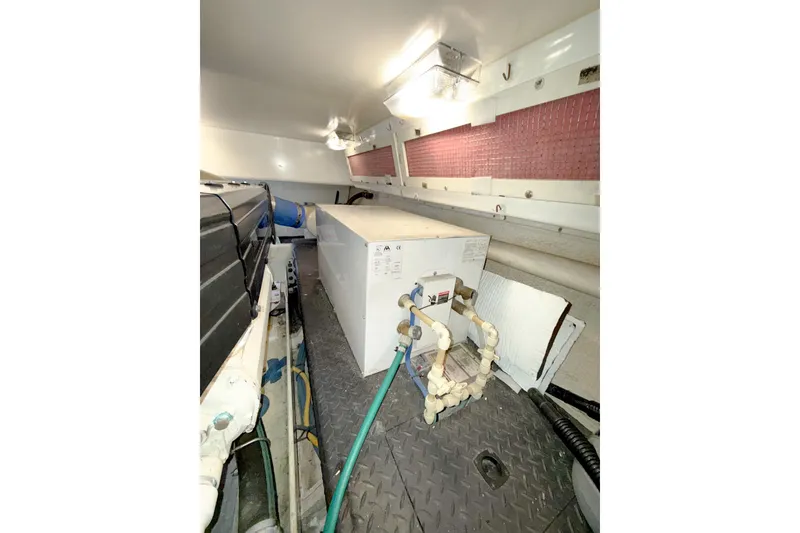 Slide: The Image of 2004 Silverton 48 Convertible engine room with equipment and piping. - 84