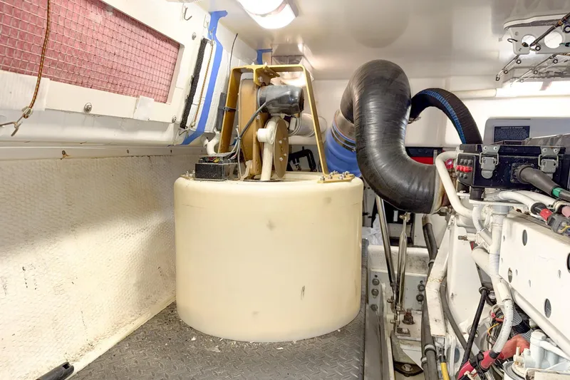 Slide: The Image of Engine room of a 2004 Silverton 48 Convertible yacht, featuring mechanical components. - 86