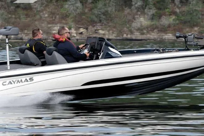The Image of 2026 Caymas CX 21 PRO boat cruising on a lake with two passengers. - 1