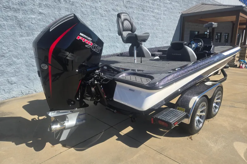 Slide: The Image of 2026 Caymas CX 21 PRO boat with Mercury Pro XS engine, parked on a trailer. - 7