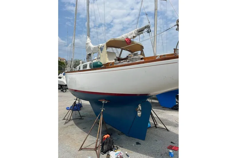 Slide: The Image of 1969 Tartan 37 sailboat on stands, undergoing maintenance in a boatyard. - 13