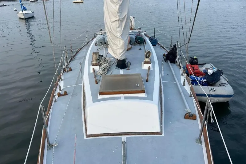 Slide: The Image of Sailboat deck view of 1969 Tartan 37, moored with inflatable dinghy. - 2