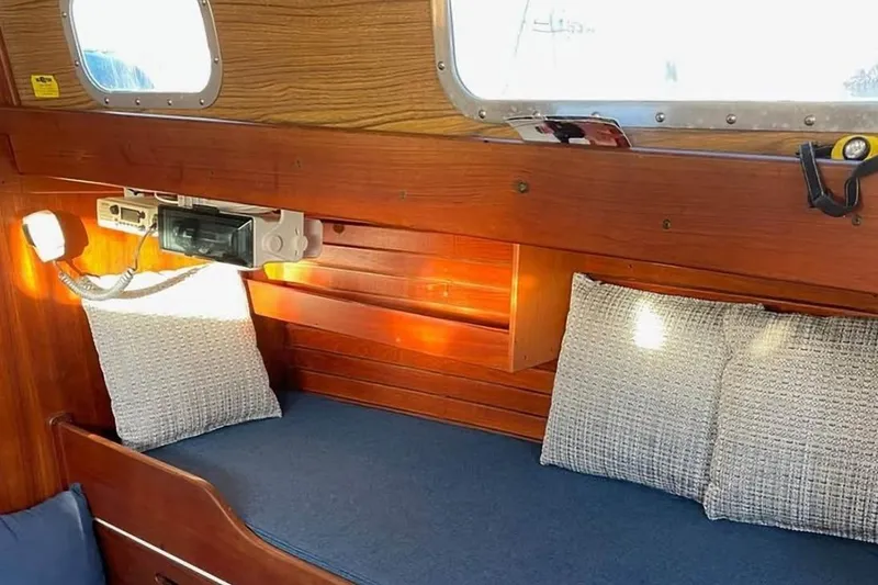 Slide: The Image of Interior of a 1969 Tartan 37 sailboat with wooden paneling and cozy seating. - 5