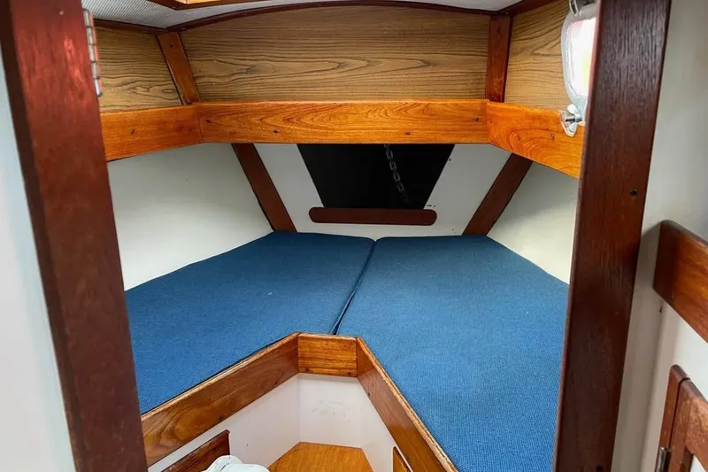 Slide: The Image of Cozy cabin interior of a 1969 Tartan 37 sailboat with blue cushions and wooden trim. - 8