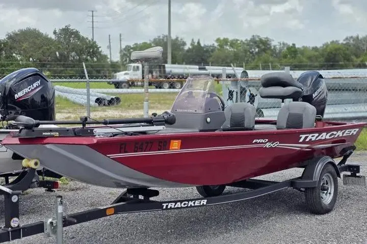 The Image of 2020 Tracker Pro 160 boat with Mercury engine on trailer, parked outdoors. - 0