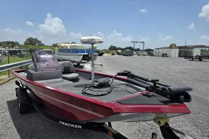 Slide: The Image of 2020 Tracker Pro 160 boat on trailer in outdoor setting, under clear blue sky. - 10